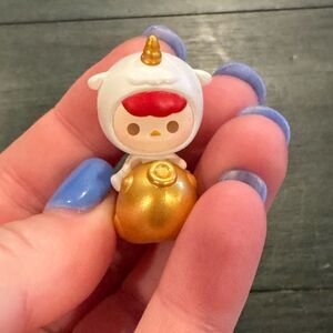 Pucky Shining Gold figure from the POP BEAN Lucky Charm series by POP MART
